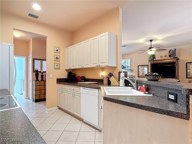 2030 Rio Nuevo Dr, North Fort Myers, FL 33917 - kitchen featuring white dishwasher, a sink, fridge, light tile patterned floors, and dark countertops