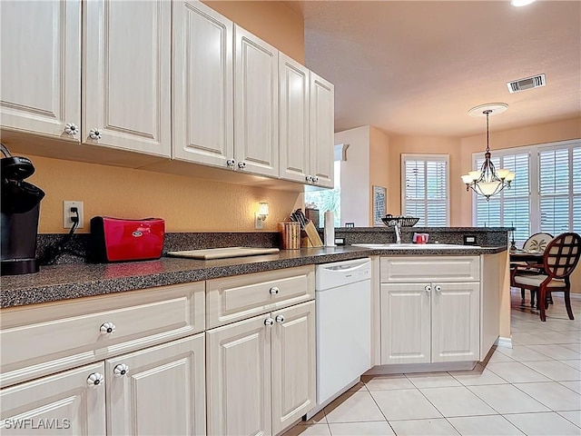 2030 Rio Nuevo Dr, North Fort Myers, FL 33917 - kitchen featuring white dishwasher, a sink, dark countertops, and white cabinets