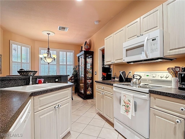 2030 Rio Nuevo Dr, North Fort Myers, FL 33917 - kitchen featuring white appliances, a sink, and dark countertops