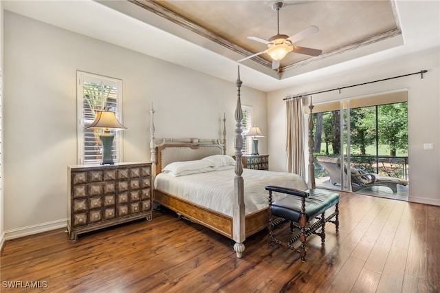 bedroom with access to exterior, baseboards, a tray ceiling, a ceiling fan, and wood-type flooring