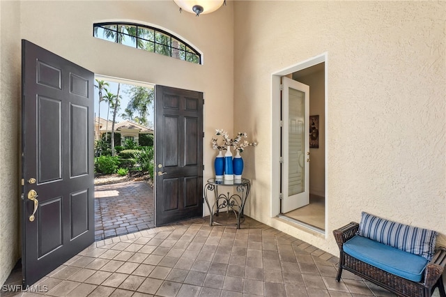 foyer with tile patterned floors and a textured wall