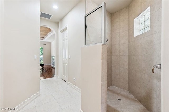 bathroom with visible vents, baseboards, tile patterned flooring, and a walk in shower