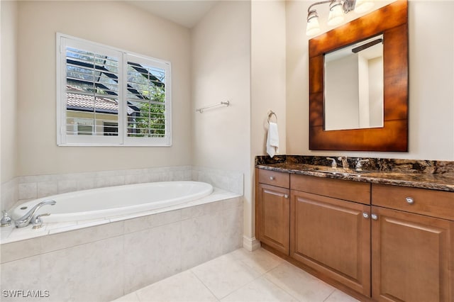 full bath featuring tile patterned floors, vanity, and a garden tub