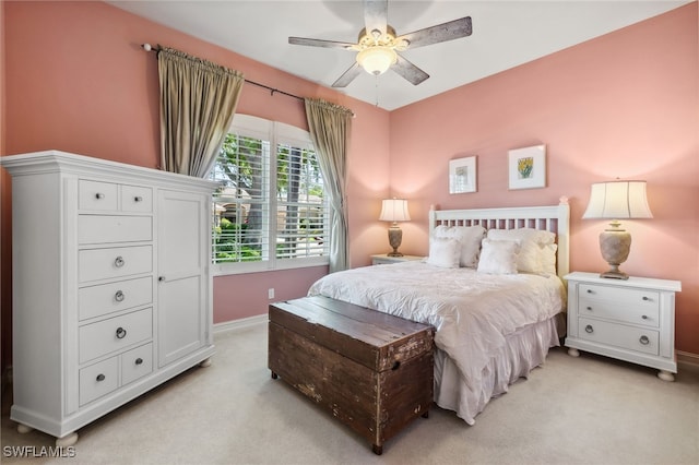 bedroom featuring ceiling fan, baseboards, and light carpet