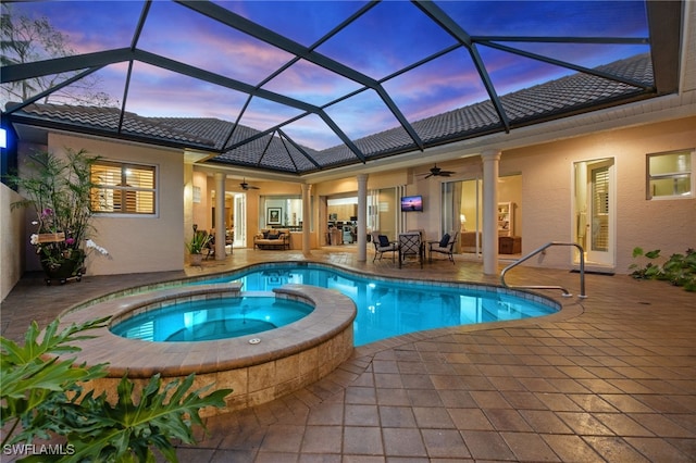 view of swimming pool with a patio, a ceiling fan, and a pool with connected hot tub