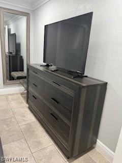 interior details with baseboards and ornamental molding