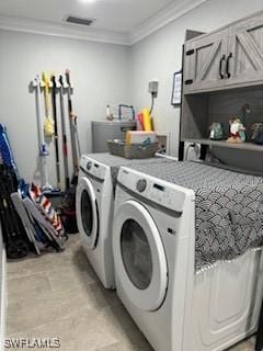 washroom featuring visible vents, cabinet space, separate washer and dryer, and ornamental molding