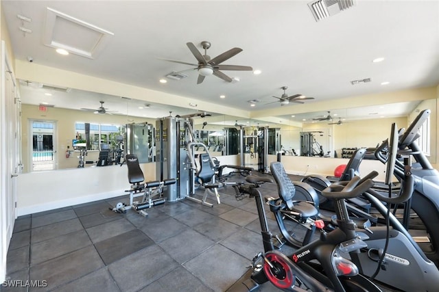 workout area featuring attic access, a ceiling fan, and visible vents