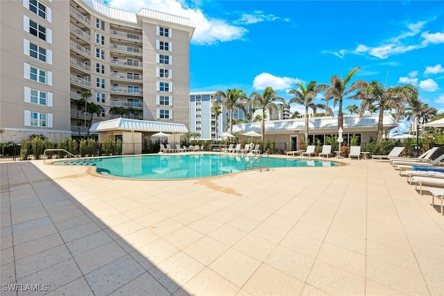 pool featuring a patio and fence