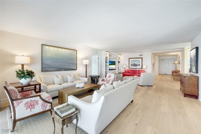 living room featuring visible vents and light wood-style floors