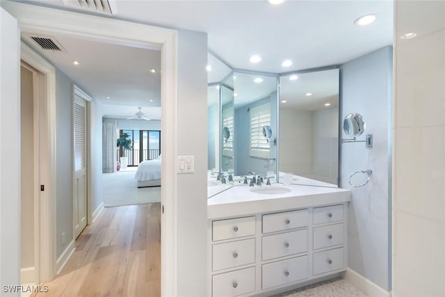 full bath featuring vanity, a healthy amount of sunlight, visible vents, and ceiling fan