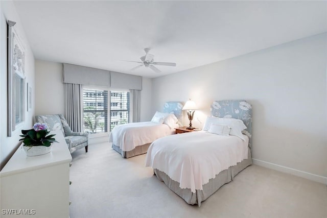 carpeted bedroom with a ceiling fan and baseboards