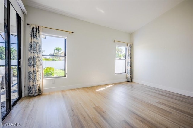 unfurnished room featuring baseboards and wood finished floors