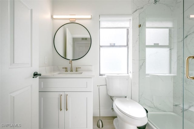 bathroom with a marble finish shower, toilet, visible vents, and vanity