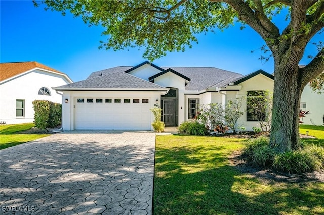 ranch-style house with stucco siding, an attached garage, decorative driveway, and a front lawn