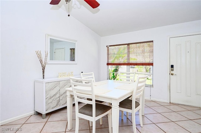 dining room featuring light tile patterned floors, ceiling fan, baseboards, and vaulted ceiling