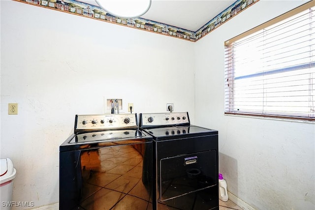 laundry room featuring baseboards, independent washer and dryer, and laundry area