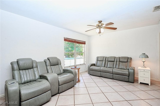 living room with light tile patterned floors, a ceiling fan, visible vents, and baseboards