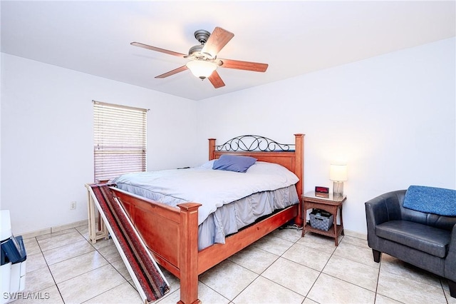 bedroom featuring light tile patterned floors, baseboards, and ceiling fan