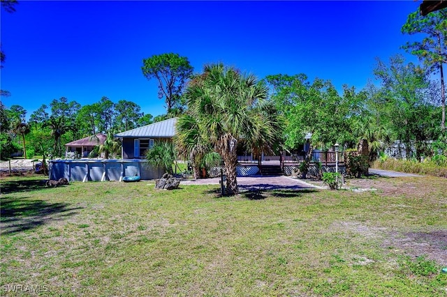 view of yard featuring an outdoor pool