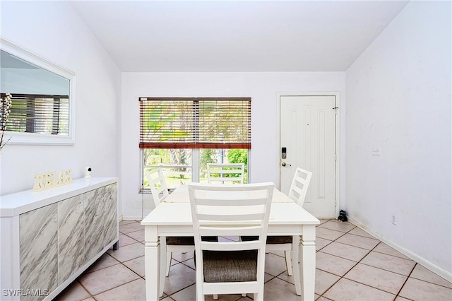 dining area with light tile patterned floors and baseboards