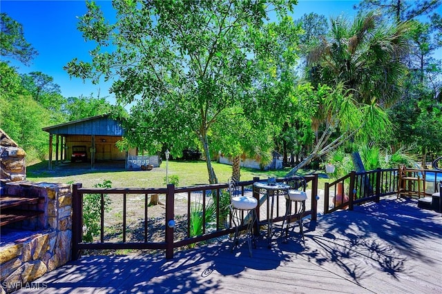 wooden deck with an outbuilding and a yard