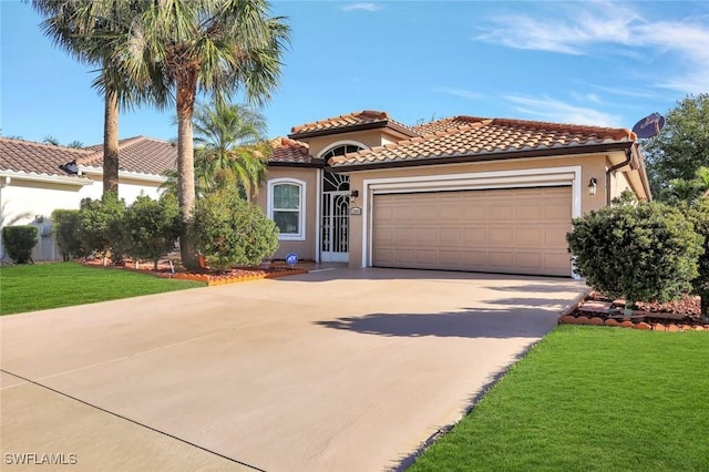 mediterranean / spanish-style house featuring stucco siding, an attached garage, concrete driveway, and a front lawn