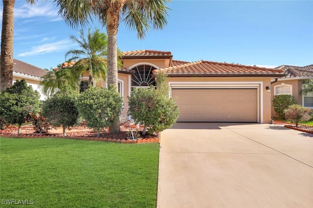 mediterranean / spanish home featuring a front lawn, a tiled roof, stucco siding, a garage, and driveway