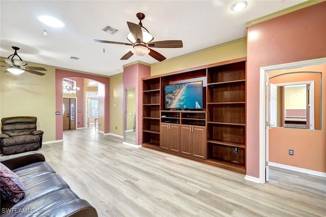 unfurnished living room featuring visible vents, arched walkways, a ceiling fan, and light wood finished floors