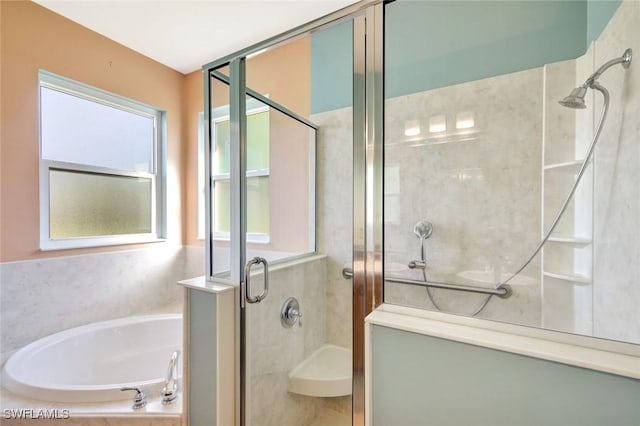 full bathroom featuring a shower stall and a garden tub