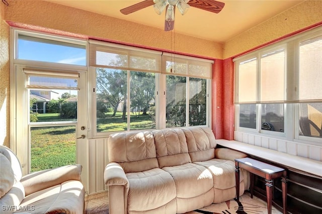 sunroom featuring plenty of natural light and a ceiling fan