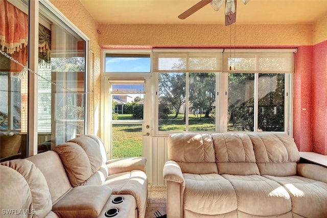 sunroom / solarium featuring ceiling fan