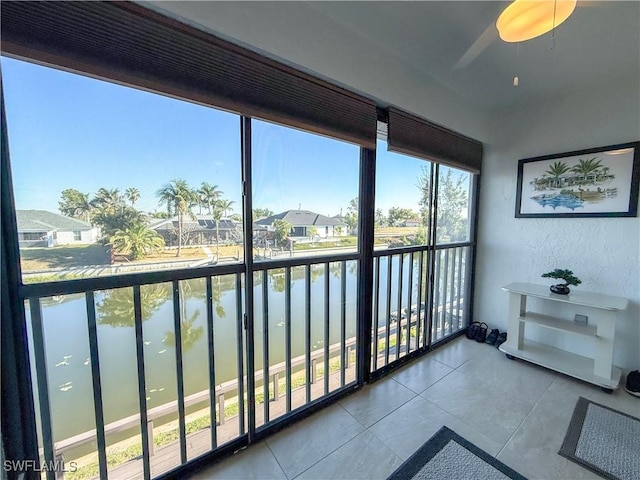 sunroom / solarium featuring a water view