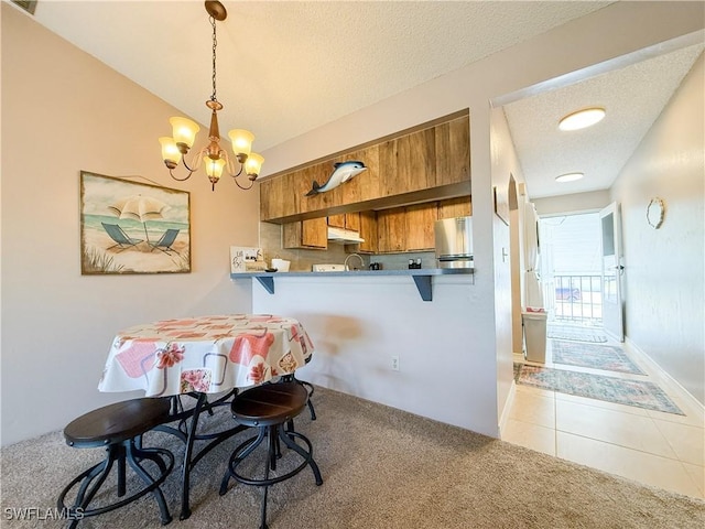 dining space with light tile patterned floors, light colored carpet, a textured ceiling, and an inviting chandelier