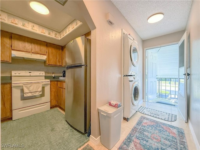 clothes washing area featuring a textured ceiling and stacked washer and dryer