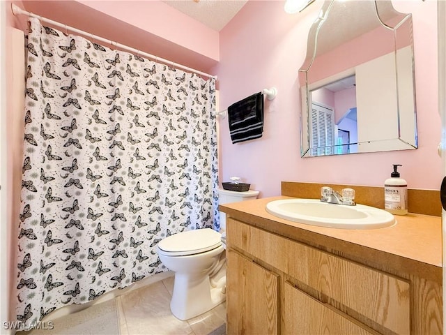 bathroom featuring vanity, toilet, a shower with curtain, and tile patterned flooring