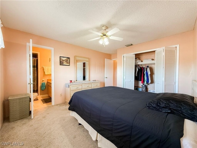 bedroom with visible vents, light carpet, a textured ceiling, a closet, and ceiling fan