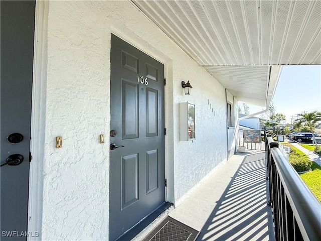 entrance to property featuring stucco siding