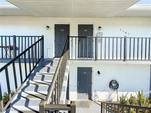 property entrance featuring stucco siding