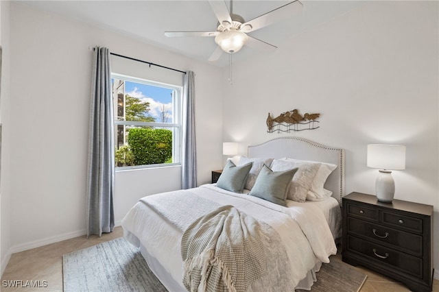 bedroom with light tile patterned floors, baseboards, and a ceiling fan