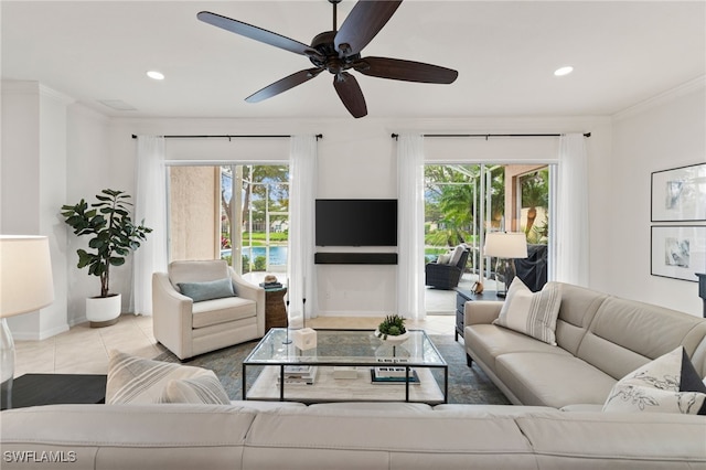 living room featuring tile patterned flooring, recessed lighting, a healthy amount of sunlight, and crown molding