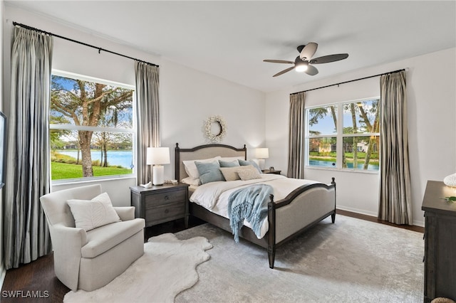 bedroom featuring a ceiling fan, wood finished floors, and baseboards