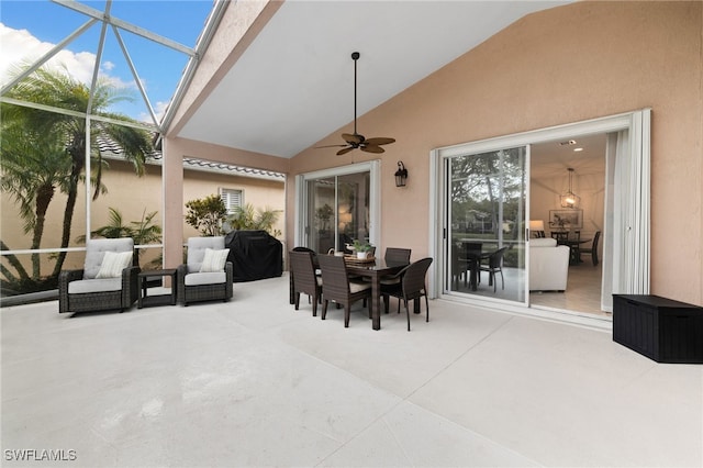 view of patio / terrace with a lanai, outdoor dining space, and ceiling fan