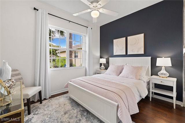 bedroom with ceiling fan, baseboards, and wood finished floors