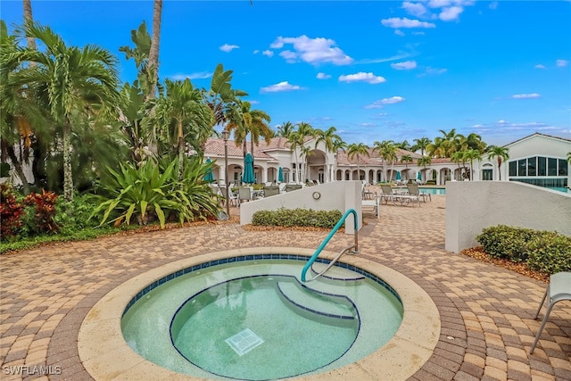 view of swimming pool featuring a hot tub