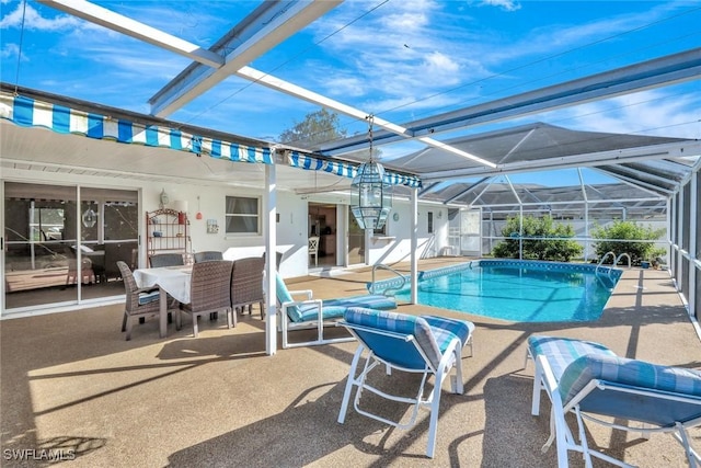 pool featuring glass enclosure, a patio, and outdoor dining space