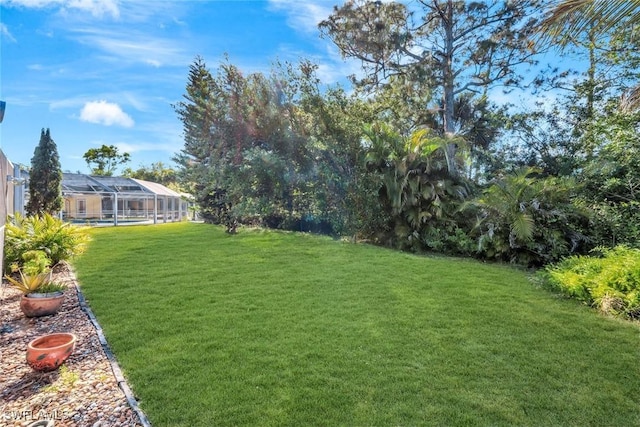 view of yard featuring glass enclosure