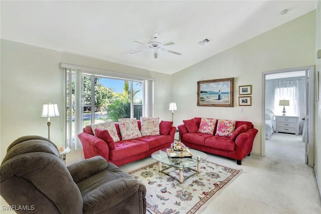 living room featuring a ceiling fan, visible vents, carpet floors, lofted ceiling, and a wealth of natural light