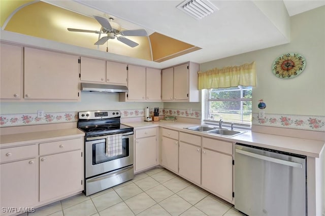 kitchen featuring visible vents, under cabinet range hood, a sink, stainless steel appliances, and light countertops