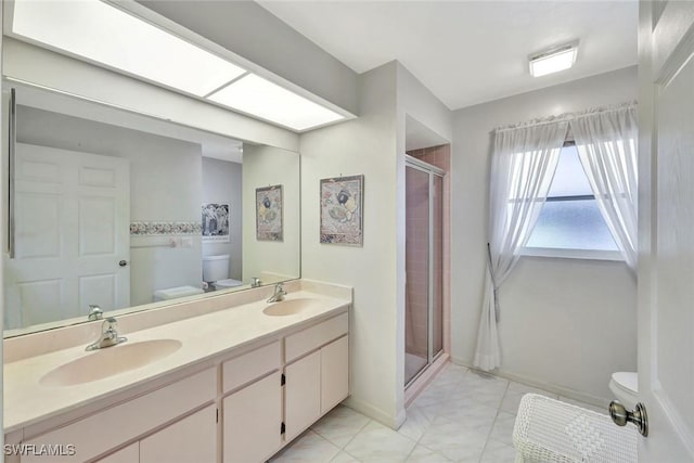 bathroom featuring a sink, toilet, double vanity, and a shower stall